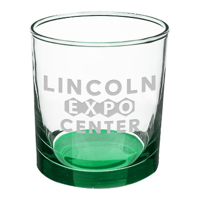 Green whiskey glass with engraved logo.