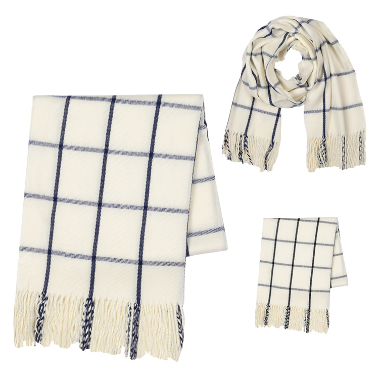 Folded blank white and blue windowpane check scarf with thread fringe.