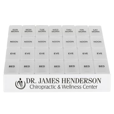 Plastic white medicine tray with a personalized imprint.