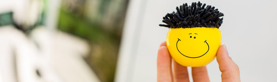 Person stress ball yellow smiley face stress ball with black hair