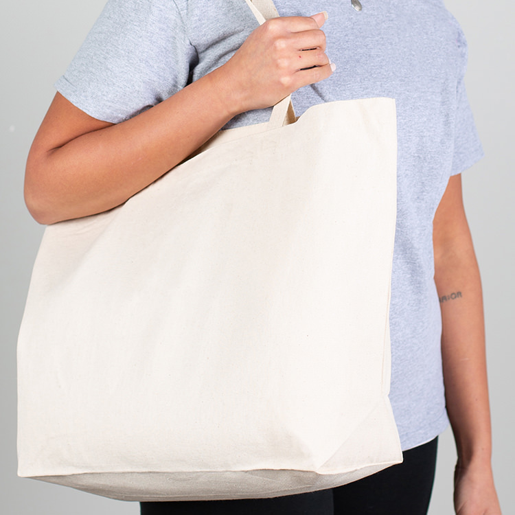 Natural cotton tote bag with 5-inch gussets and reinforced handles.