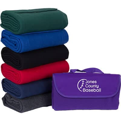 Customizable purple fleece blanket that can fold within itself with attached handle.