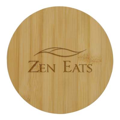 Natural round bamboo cutting board with custom laser engraved imprint.