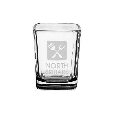 Black shot glass with engraved logo.