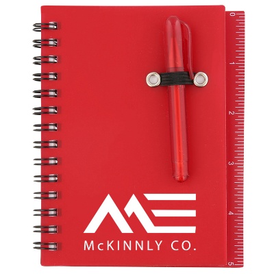 Custom logo on small carolina blue notebook with sticky notes and ruler.